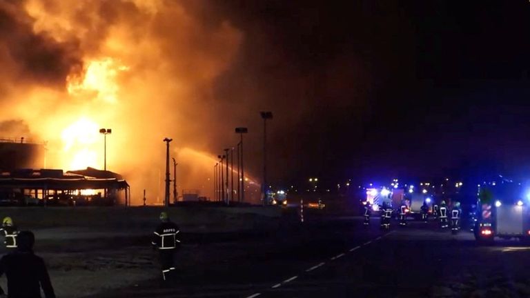Firefighters work at the site after reported Iranian strikes triggered fire at fuel tanks near the airport, in Muharraq.
Pic: Reuters