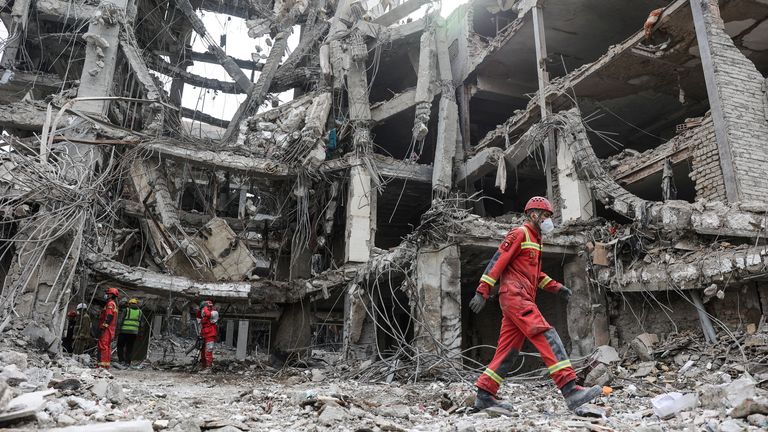 Emergency personnel work at the site of a strike, amid the U.S.-Israeli conflict with Iran, in Tehran, Iran, March 12, 2026. Majid Asgaripou