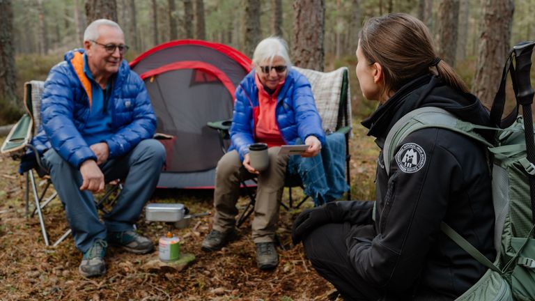 A Cairngorms National Park Authority ranger with campers using a gas stove. Pic: Catriona Parmenter 