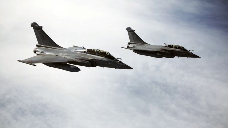 France's Rafale aircraft, which are used to carry nuclear weapons, flying overhead before Macron's speech on Monday. Pic: Reuters