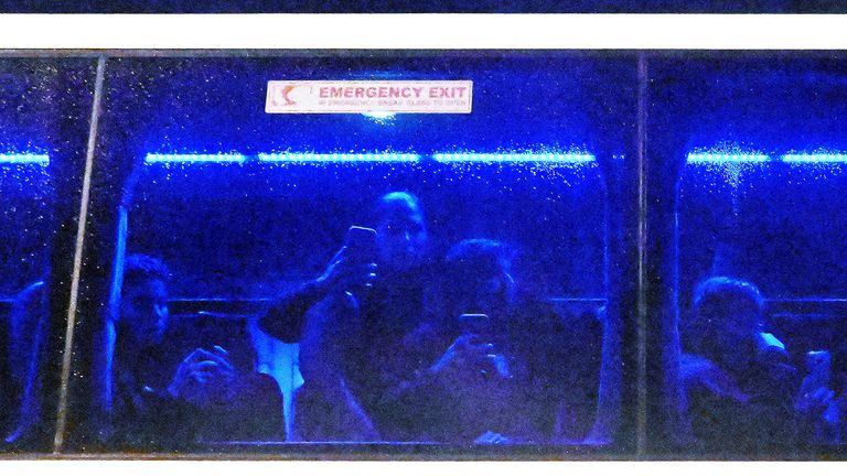 Iranian players on the bus after the defeat to the Philippines. Pic: AAP/via Reuters