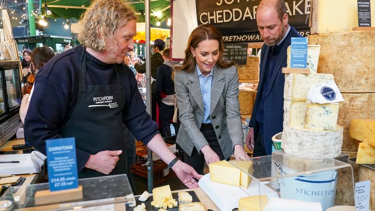 Stall holder Todd Trethowan shows his cheese to Prince and Princess of Wales as they visit Borough market in London. Pic: PA