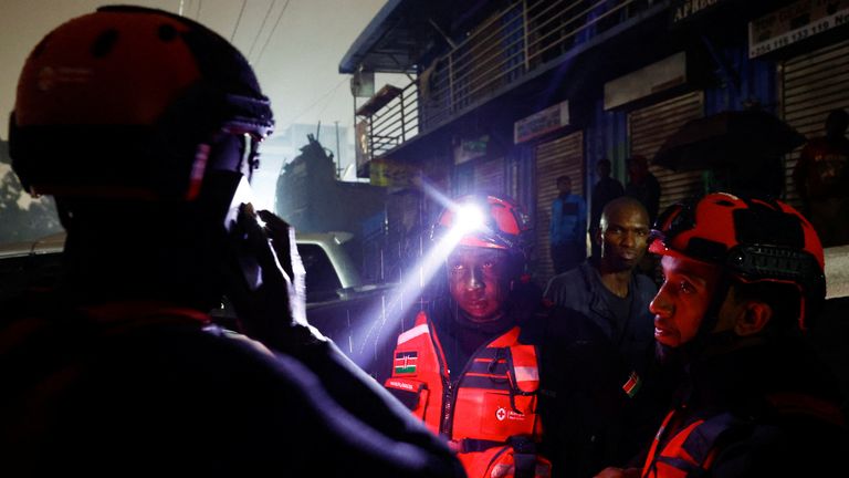 Members of the Kenya Red Cross gather to search for bodies trapped in the wreckages of vehicles. Pic: Reuters