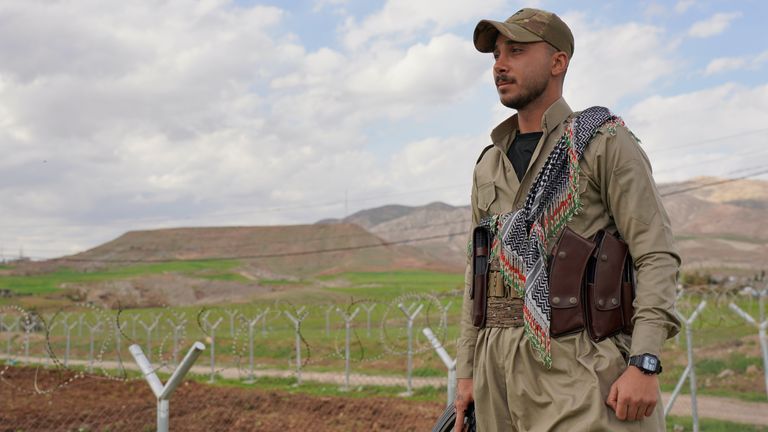 A member of the PDKI stands at a checkpoint leading to their base in Koya, Iraq. Pic: AP