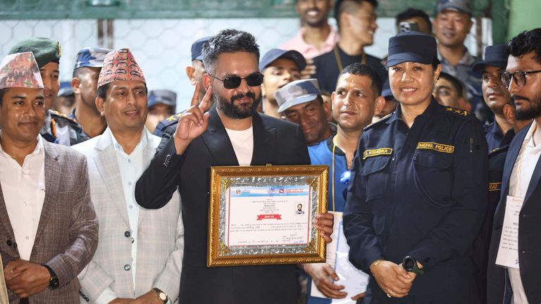 Mr Shah receives his victory certificate. Pic: AP