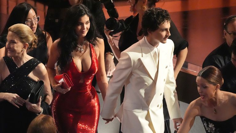 Kylie Jenner and Timothee Chalamet making their way to their seats. Pic: AP