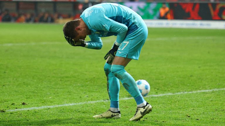 Bochum's Patrick Drewes reacts after being hit by a lighter. Pic: Reuters