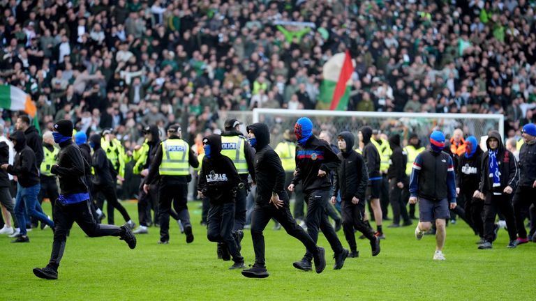 Fans run on the pitch after Celtic's Scottish Cup win over Rangers. Pic: PA