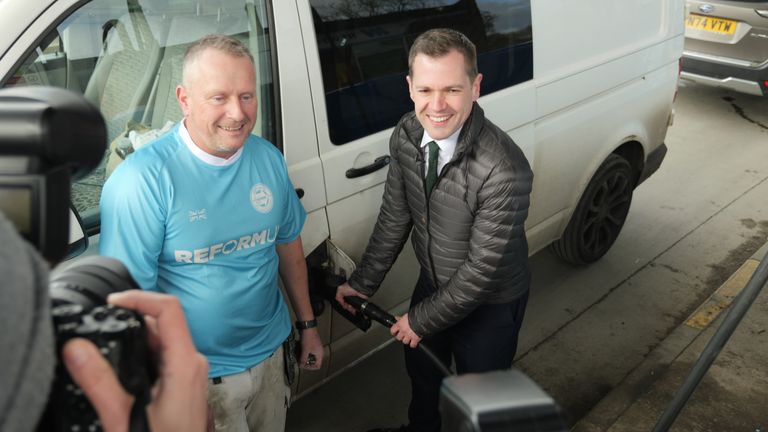 Robert Jenrick, right, fills up