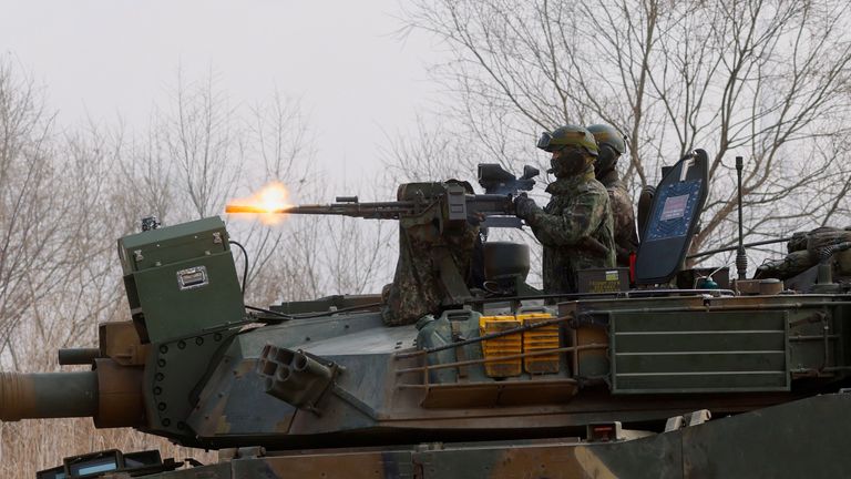 South Korean Army soldiers fire a machine gun mounted on a K1A2 tank during the exercise. Pic: Reuters