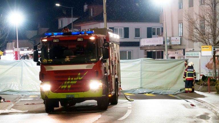 Barriers surrounding the charred remains of a fatal bus fire in Kerzers, Switzerland. Pic: AP