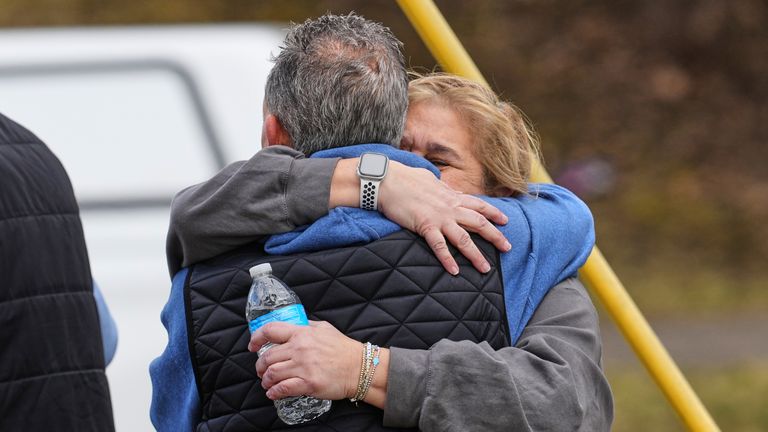 People embrace after surviving the attack. Pic: AP