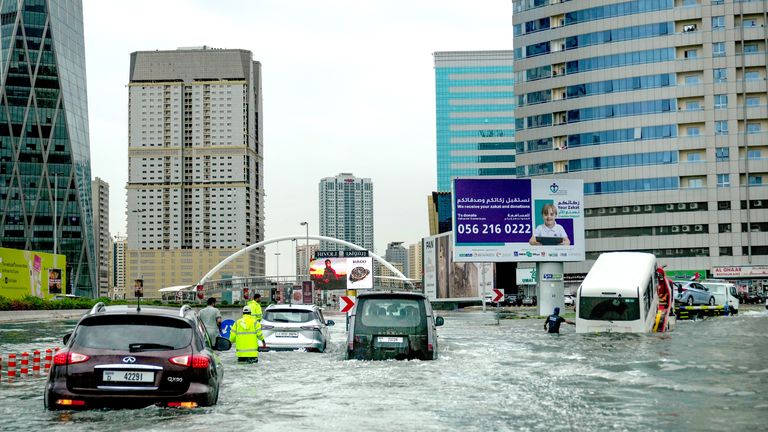 Vehicles are stuck on a flooded Dubai street after heavy rains. Pic: AP