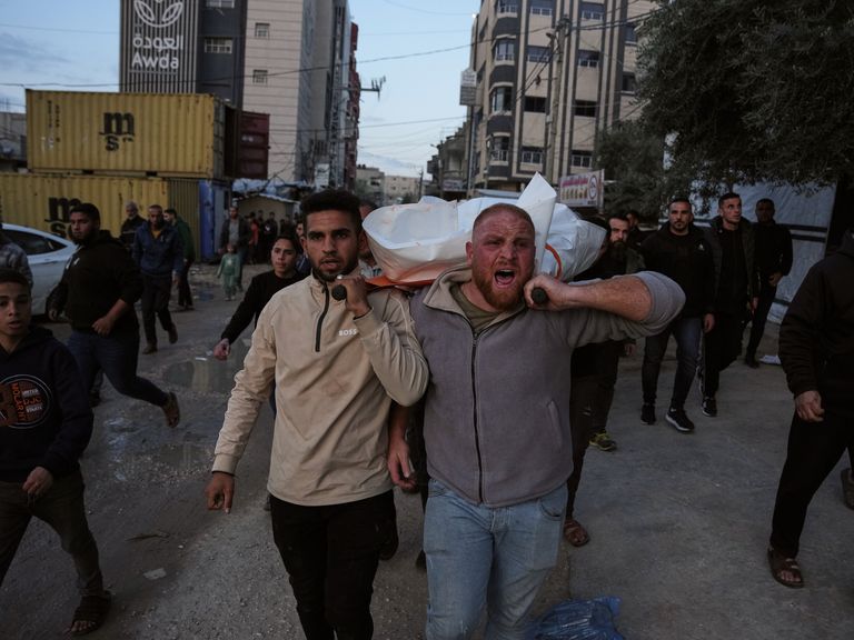 Mourners carry the body of a Palestinian policeman killed in an Israeli military strike on Gaza. Pic: AP