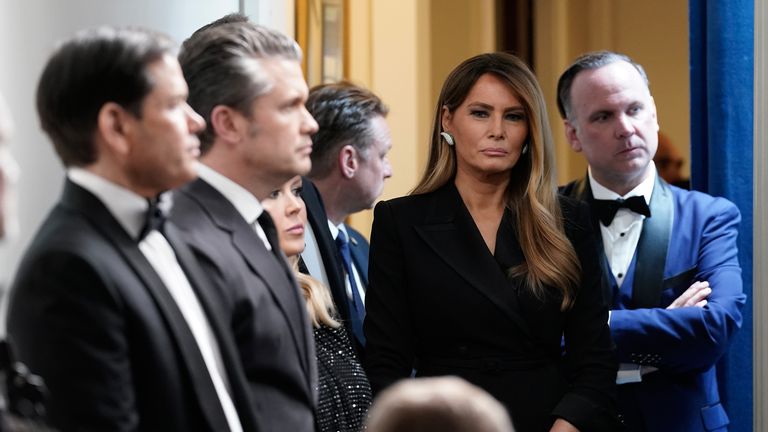 Melania Trump listens to Donald Trump speak after being safely evacuated from the ballroom . Pic: AP/Jose Luis Magana