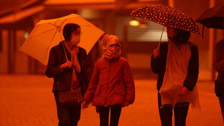 People have been wearing face masks to protect themselves. Pic: Reuters
