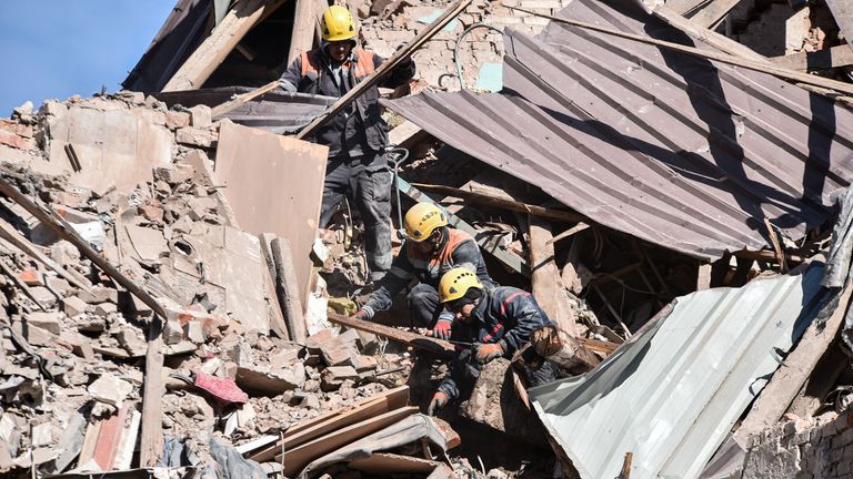 Rescue workers clear the rubble in Dnipro. Pic: AP