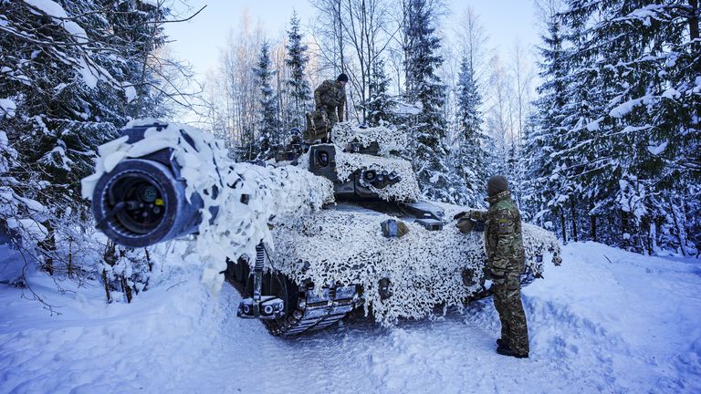 Troops by a Challenger 2 main battle tank during a British training exercise in Estonia in February 2026. Pic: PA