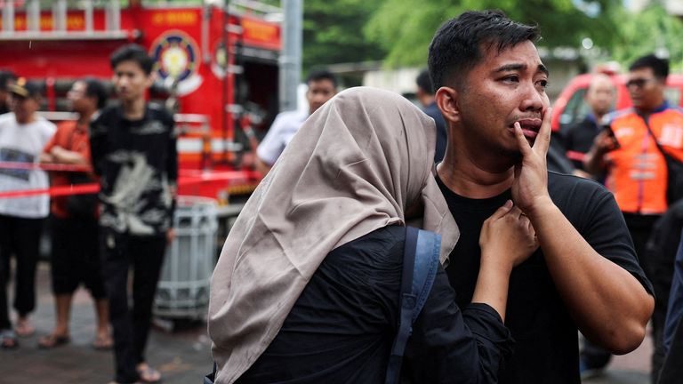 People wait for news about loved ones on board the trains