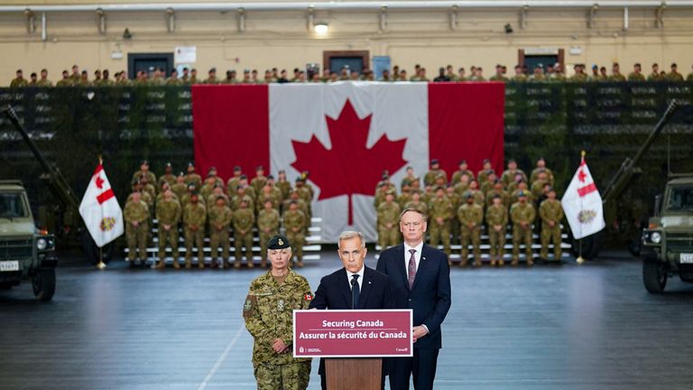 Canada's Prime Minister Mark Carney, Chief of the Defence Staff Jennie Carignan and Minister of National Defence David McGuinty