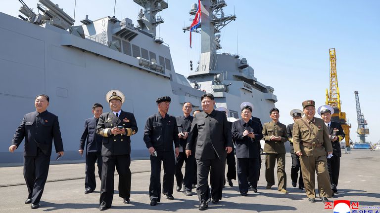 Kim Jong Un (C) near the Choe Hyon with senior defence officials and naval commanders. Pic: KCNA/AP
