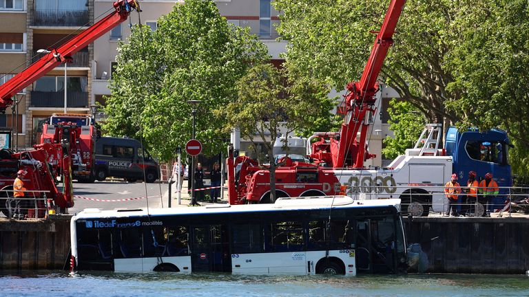 Workers recovering the vehicle. Pic: Reuters
