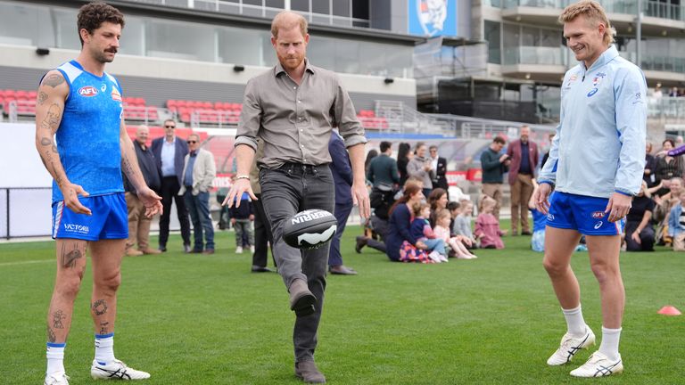 Prince Harry joins players from the Western Bulldogs. Pic: PA