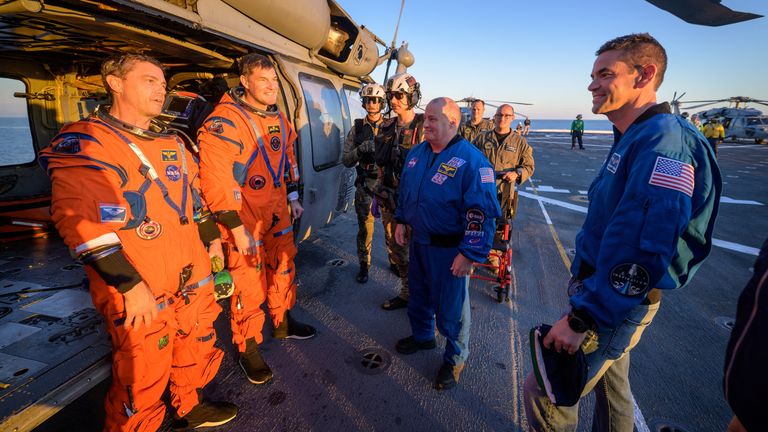 Reid Wiseman and Jeremy Hansen on the flight deck of USS John P Murtha. Pic: Reuters