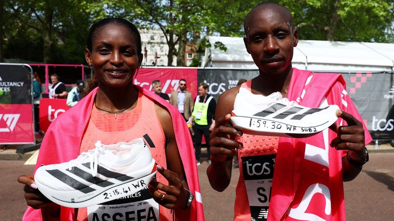 Sawe and Ethiopia's Tigst Assefa hold up their Adidas Adizero Adios Pro Evo 3 shoe after each setting a new world record. Pic: Reuters
