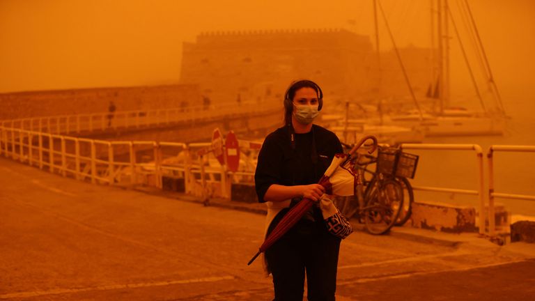 A woman in the port city wearing a face mask. Pic: Reuters
