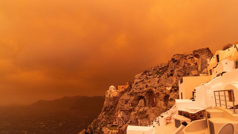 The skies above Santorini have turned orange-red due to the dust from Africa. Pic: AP