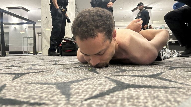Suspect Cole Thomas Allen lies on the floor. Pic: Reuters
