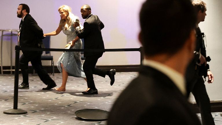 Guests run down the hotel hall. Pic: AP/Tom Brenner