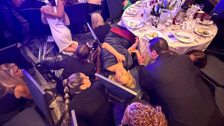 Guests take cover on the floor. Pic: Reuters/Evan Vucci