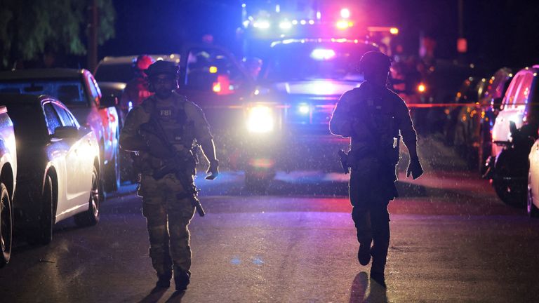 Officials outside the hotel. Pic: Reuters