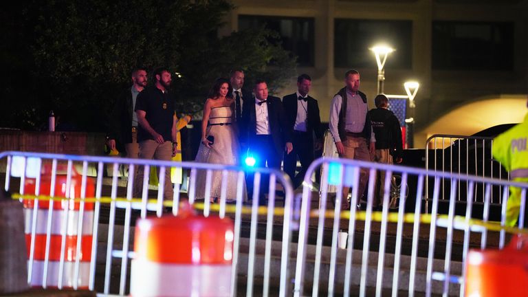 Evacuated guests outside the Washington Hilton Pic: AP/Allison Robbert