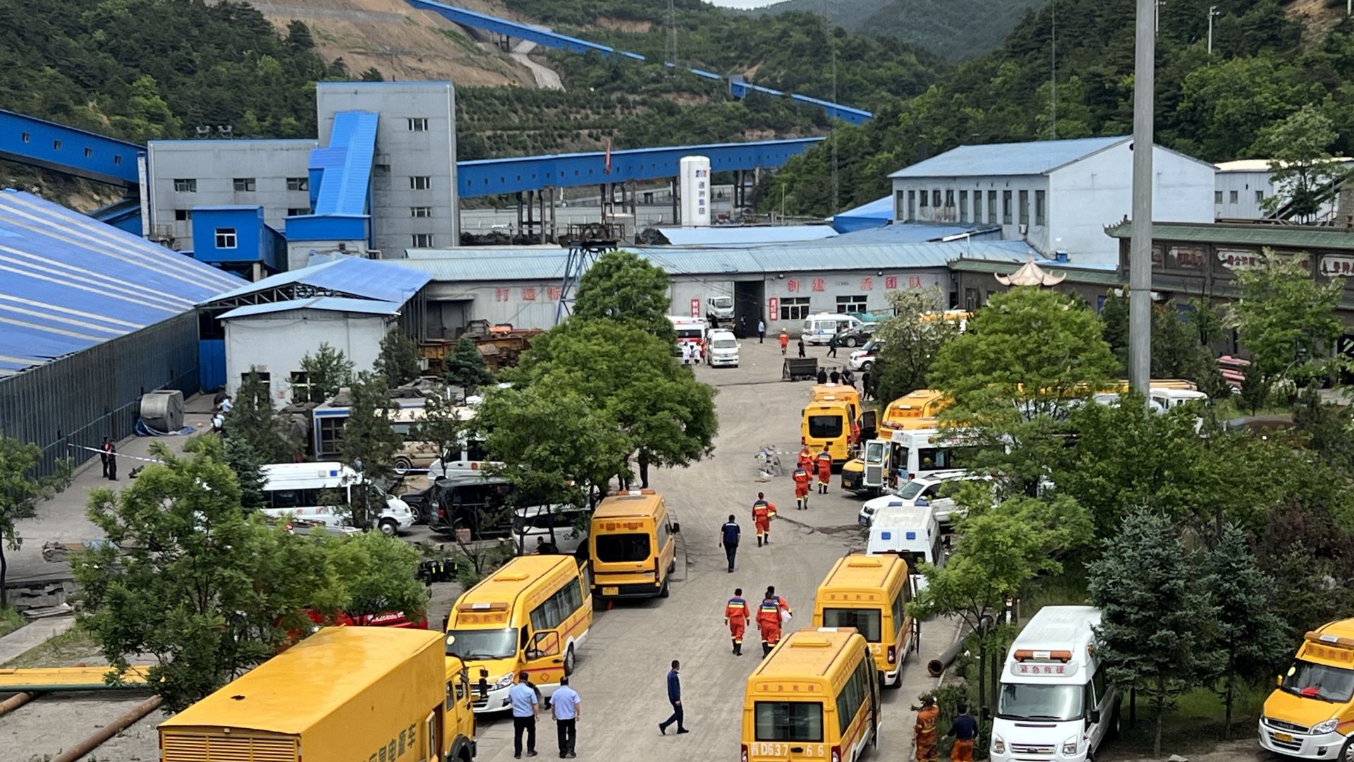 Rescue workers at a coal mine entrance following a deadly gas explosion in northern China that killed 90 miners.