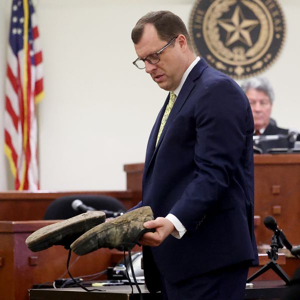 Prosecutor James Stainton holds the shoes Tanner  wore when he killed Athena. Pic: AP