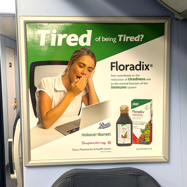 A compliant Floradix advert on a South Western Railway train reads: 'Iron contributes to the reduction of tiredness'