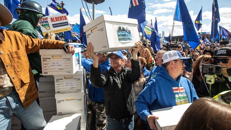 Supporters carry boxes of signatures calling for a separation referendum. Pic: AP