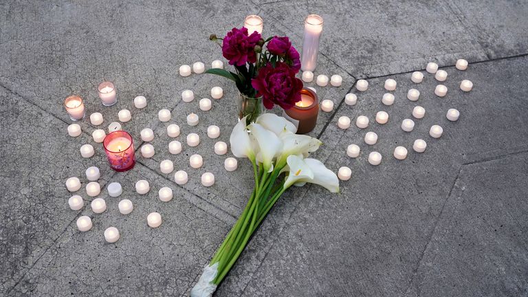 Candles and flowers placed during a vigil outside the site of the incident. Pic: Reuters