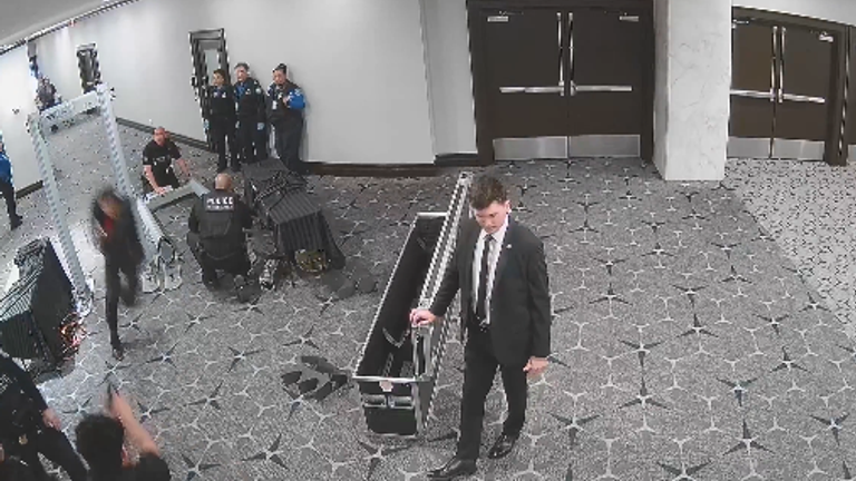 Only one agent appears to raise their gun as he passes through. Pic: @USAttyPirro