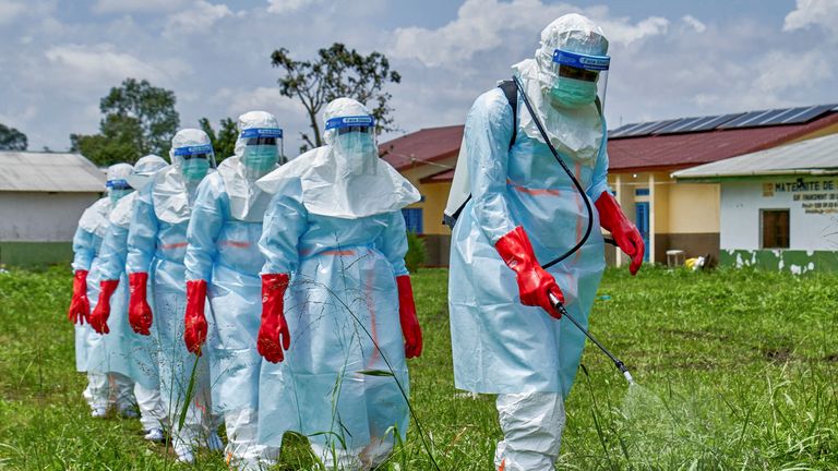Red Cross workers disinfect an area around Rwampara general hospital. Pic: Reuters