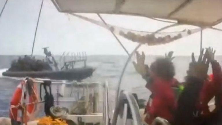 Footage showed people on a flotilla boat raising their hands. Pic: Global Sumud Flotilla/AP