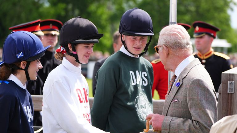 The King meets riders at the Royal Windsor Horse Show. Pic: PA
 qhiukiqrihtinv