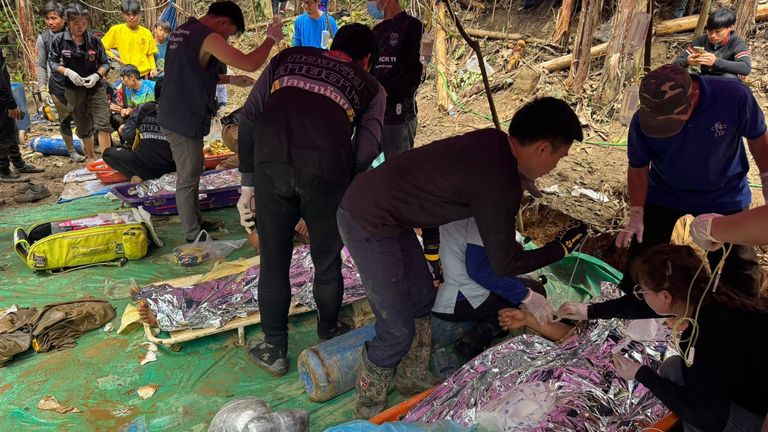 The rescuers and evacuated villagers. Pic: Association Of Volunteers For Lao People/AP