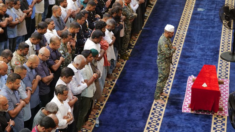Maldivian President Mohamed Muizzu prays in front of the remains of Mr Mahudhee. Pic: AP