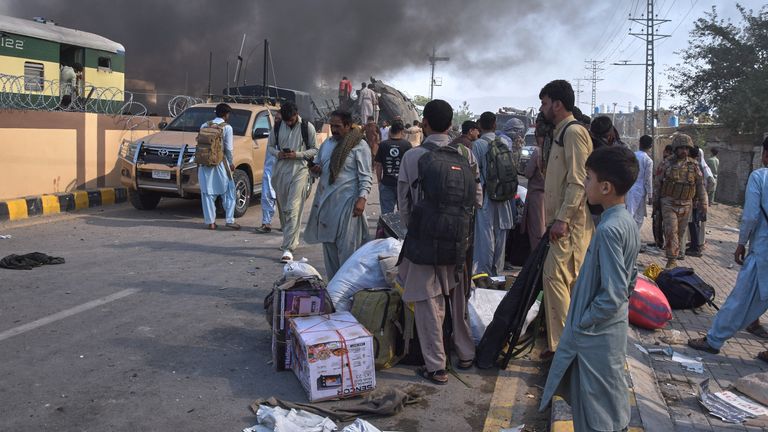 Volunteers look for victims at the site of the crash. Pic: AP