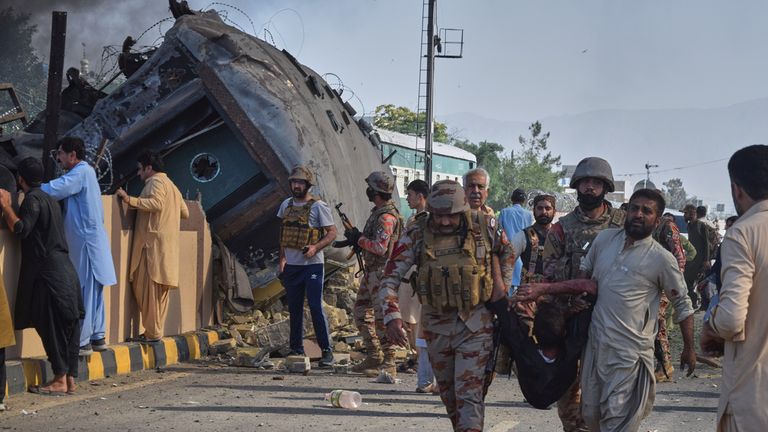 Security forces carry an injured victim at the scene in Quetta, Pakistan. Pic: AP