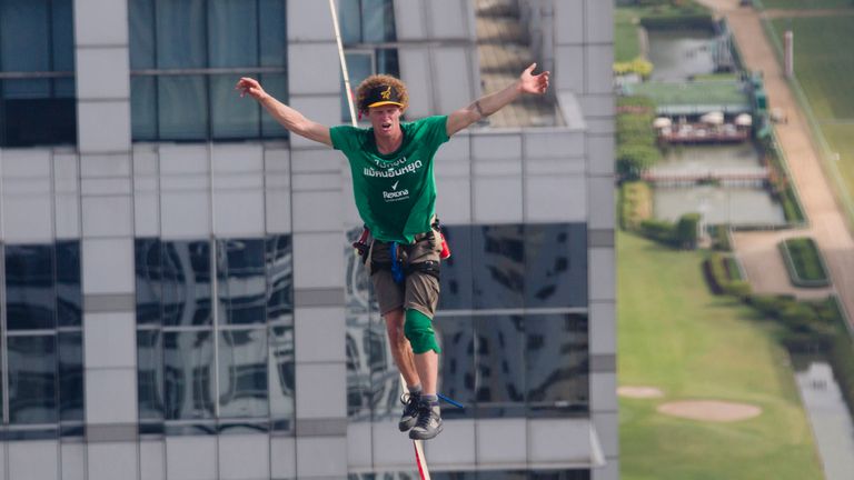 Andy Lewis slacklining in Bangkok, Thailand on 23 July, 2014. Pic: AP